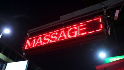 Red neon sign of the word 'Massage', Chiang Mai, Thailand.