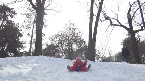 POV of a Child Sledding in Snow, View of Little Girl Playing, Accident while Sledging in Park in Winter