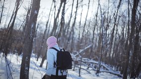 Lonely Woman Snowshoeing in Forest on a Beautiful Winter Day
