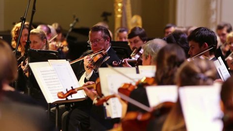 RUSSIA, MOSCOW - OCT 4, 2012: Violinists playing classical music with orchestra at Moscow Tchaikovsky Conservatory during Gala evening dedicated to 100 anniversary of All-Russian Museum Association