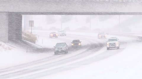 PORTLAND, OREGON - CIRCA 2014: Traffic driving along freeway during heavy snow storm.