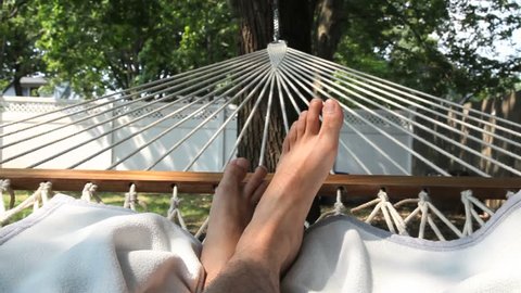 Man Resting in Hammock with His Feet Showing