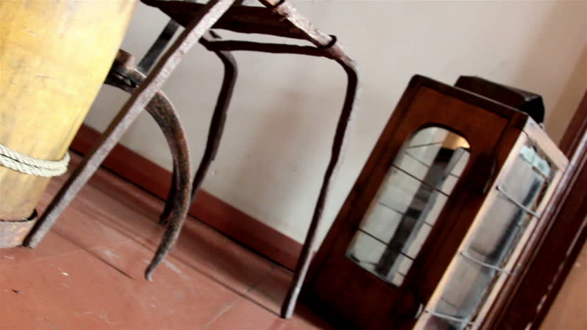 Three old wooden barrels with an old lamp placed inside a room