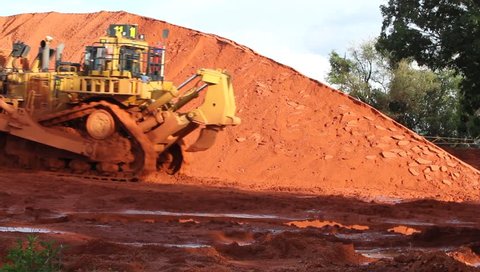Piles of mining Bauxite in Weipa, Queensland, Australia Bauxite is an aluminum ore and is the main source of aluminum. Big bucket scoop bulldozer mining technology using to move bauxite mine.