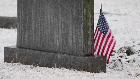 American Flag Near Headstone in Winter