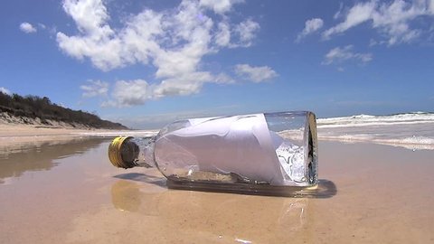 Wave comes in and washes a bottle with a message in it into the lens of the camera.
