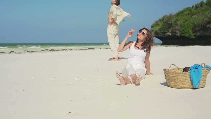 Young couple relaxing on beautiful exotic beach

