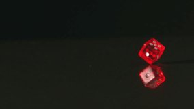 Red dice spinning on black background in slow motion - Powered by Shutterstock - Get 15% off with code: PIKWIZARD15