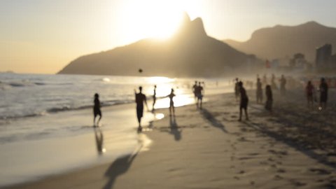 Silhouettes of Brazilians playing beach football at sunset on Ipanema Beach Rio de Janeiro Brazil