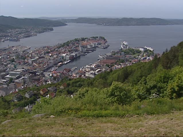 BERGEN, NORWAY - View from Mount Floyen at Bergen City center + zoom in trade houses of Bryggen, world heritage.