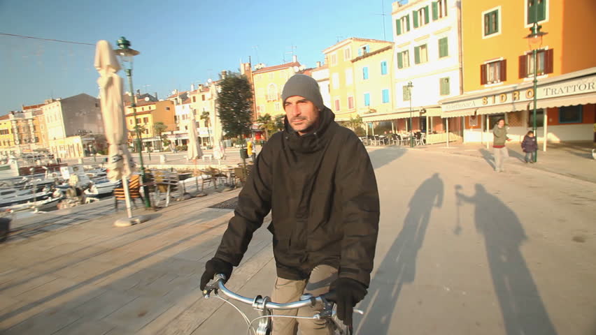 Man cycling on road in Rovinj, Croatia.