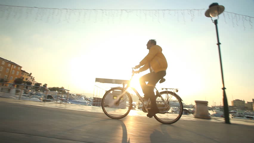 Man cycling on road in Rovinj, Croatia.