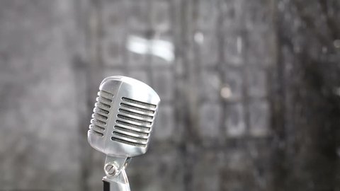 Shiny vintage microphone in studio with falling snow