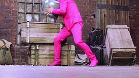 Man in pink suit throwing TV on the floor and crashed it