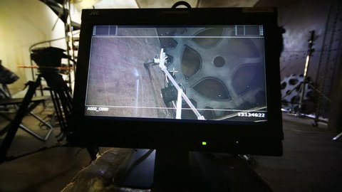 Monitor at movie set of musical video clip with man in pink suit
