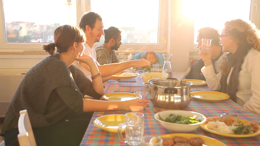 Group of friends eating lunch at home with flare | Shutterstock HD Video #5693747