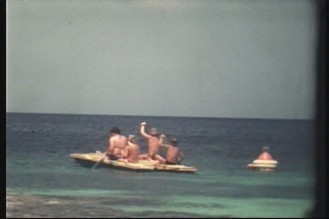 8mm - kids playing in ocean on raft. Shot in the 70s.