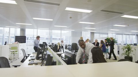 Attractive diverse business group working together in large modern city office.
