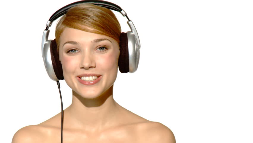 Portrait of beautiful and sexy woman singing in headphones 
