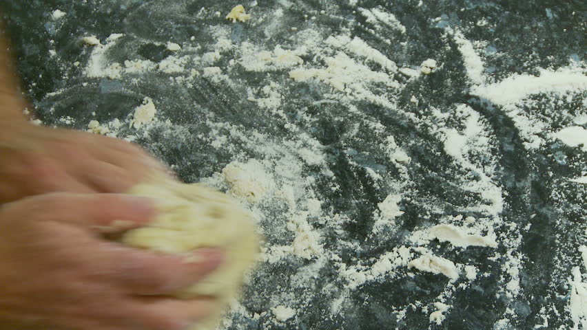 Kneading dough on a flour covered bench
