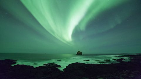 Aurora borealis seen off the rugged coast of Reykjanes, Iceland