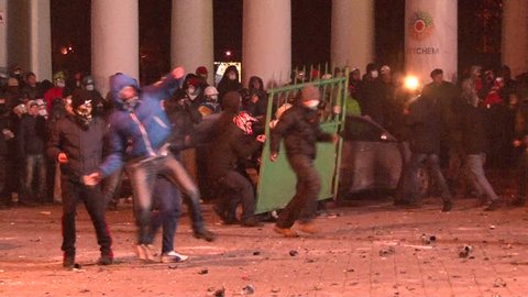 KIEV, UKRAINE - JANUARY 20, 2014: Protesters attacked police during clashes in Kiev on the street Grushevskogo, throwing stones, set cars alight