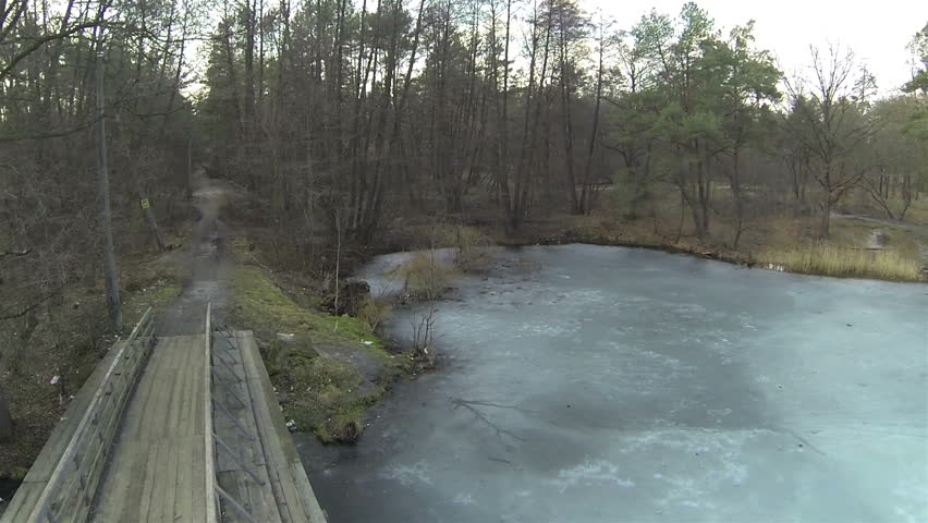 Wooden Bridge  over frozen  winter river . Aerial