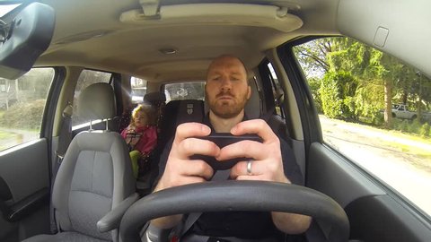 This bad parent is texting and driving with his daughter in the car