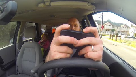 This bad parent is texting and driving with his daughter in the car