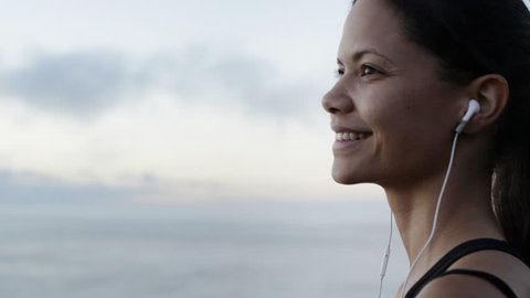 beautiful woman portrait looking at ocean view listening music