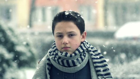Young sad boy in snowy weather, super slow motion, shot at 240fps
