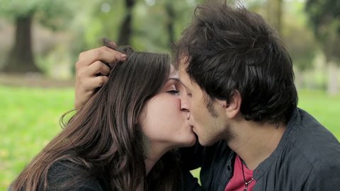 Beautiful young couple kissing in the park