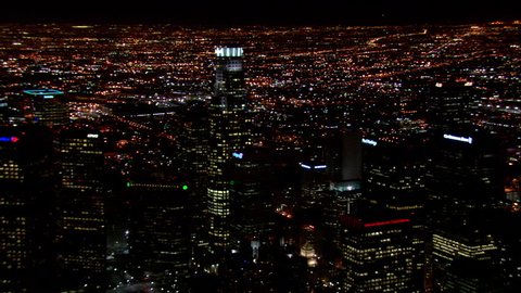 Downtown Los Angeles Night. This clip is an aerial shot of downtown Los Angeles, California at Night, It zooms out to show all of the buildings that are lit up.