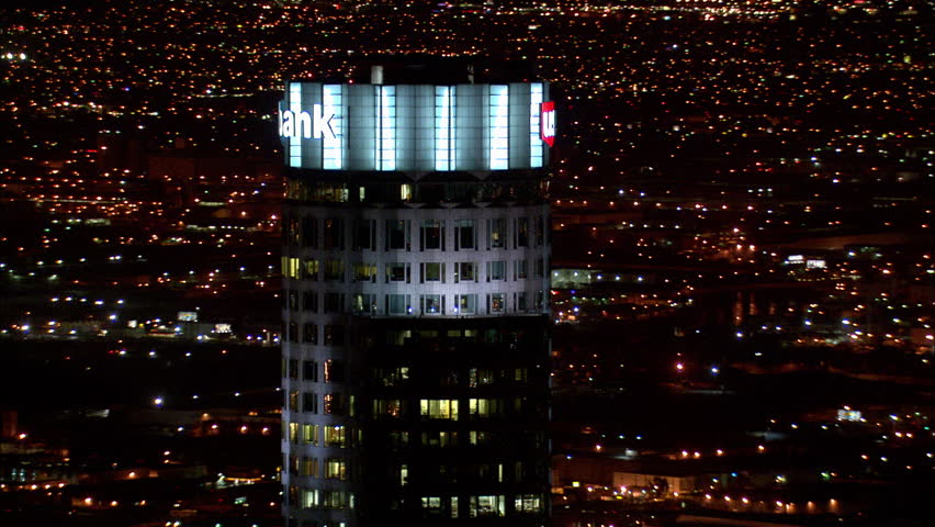 Los Angeles Night. This clip is an aerial shot of a top of a skyscraper in downtown Los Angeles, California that zooms out to show the rest of the city lit up at night. Royalty-Free Stock Footage #5745467
