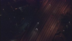 los angeles freeway night. This clip is an aerial shot of cars driving on a freeway in Los Angeles, California at night then tilts up to show the city lights and freeway.