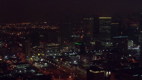 Houston Buildings at Night. A beautiful aerial view of Houston's towering buildings and its main event stadium, the Toyota Center.