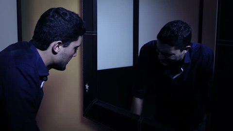 sad man looking in the mirror