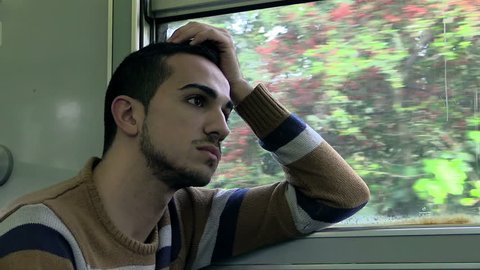 Sad young man on a train