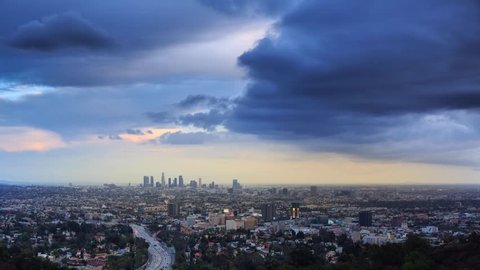 4K. Los Angeles city skyline timelapse. Transition from day to night. View from Hollywood Hills on freeway 101 and downtown LA. Stockvideó