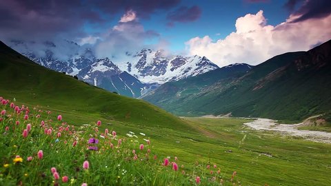 Majestic sunset at the foot of  Mt. Shkhara. Dramatic sky. Upper Svaneti, Georgia, Europe. Caucasus mountains. Beauty world. HD video clip (High Definition)