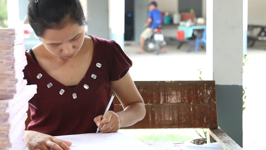 Woman drawing on white canvas.dolly shot.