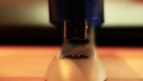 A close up shot of a hand using a stapler in an office