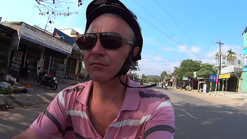 Closeup of a man manages motorbike.