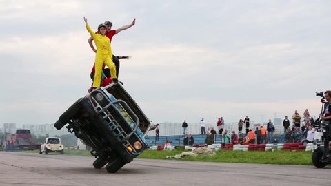MOSCOW, RUSSIA - AUG 25, 2012: Stunts stand on car riding on two wheels at Festival of art and film stunt Prometheus in Tushino. Festival was organized in 1998.