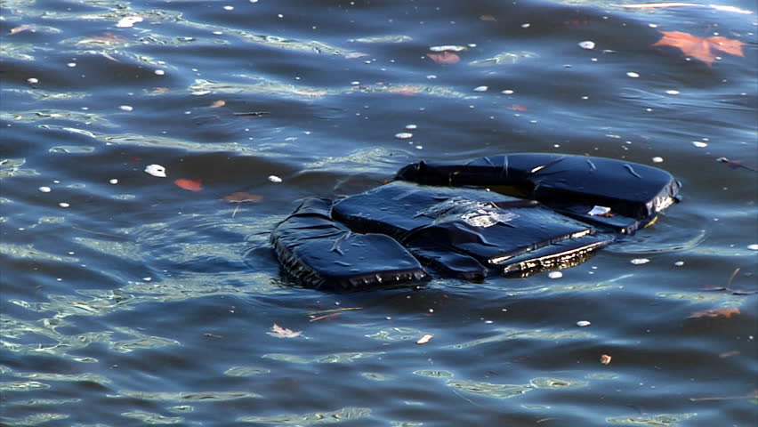 A discarded life jacket floats in the water.