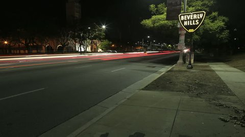Beverly Hills, California - March 4, 2014: Traffic passes in night time-lapse of famous Beverly Hills Sign and Fairbanks Center for Motion Picture Study on March 4, 2014 in Los Angeles, California.