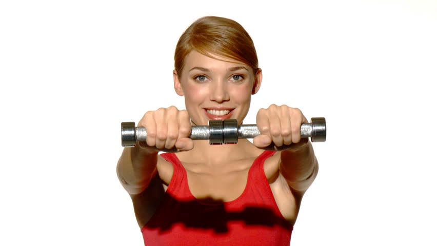 Young beautiful and relaxed lady exercising with dumbells 