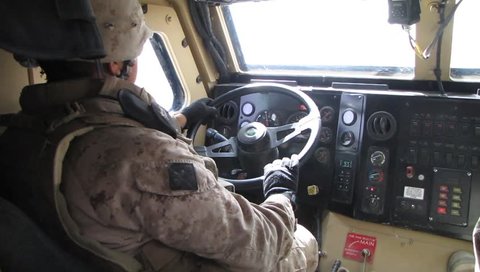 U.S. Marine Drives in Combat Gear Drives a Humvee