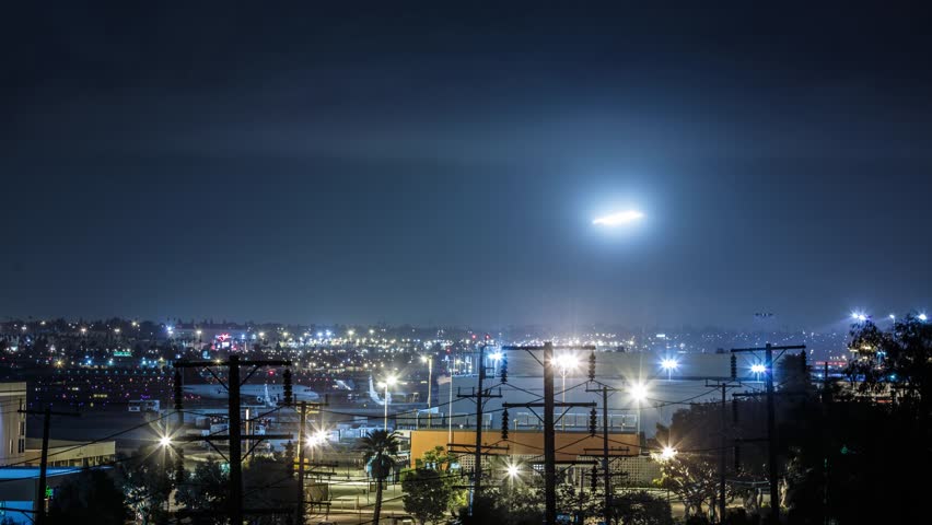 4K. Planes landing in Los Angeles LAX airport at cloudy night. Timelapse.