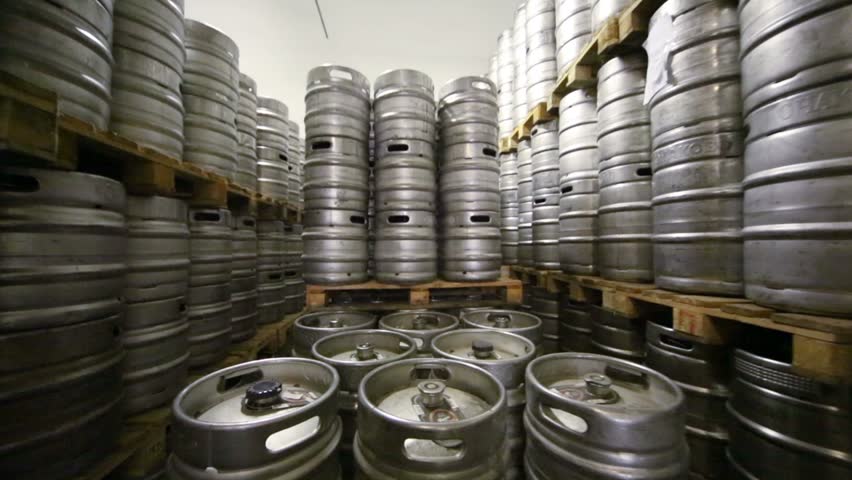 Movement along high rows of metal beer kegs in warehouse Royalty-Free Stock Footage #5777423